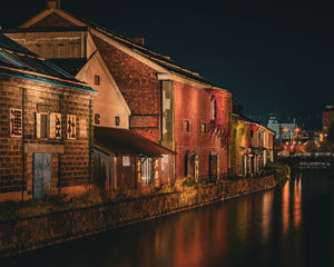 Japanese warehouse buildings reflected in Otaru Canal after rain