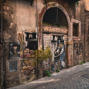 Weathered graffiti and street art on an old Tivoli building