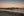 Warm sunset above coastal homes and tidal flats in Maine