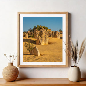 Pinnacles Desert landscape with golden sand stone formations and blue sky