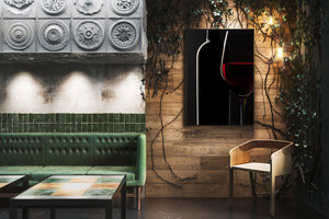 Studio photograph of red wine glass and bottle silhouette
