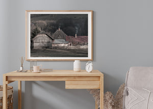 Wooden barns with corrugated roofs and pale farm fencing