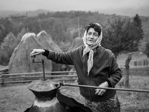 Black and white portrait of a woman on a rural Romanian farm