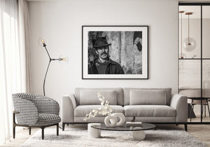 Mustached Romanian man photographed against worn plaster walls