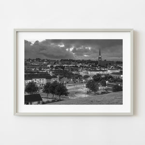 Black and white Rosemount Northern Ireland cityscape beneath heavy clouds