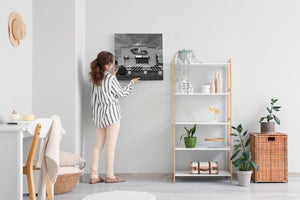 Black and white roadside building with car artwork and guardrail