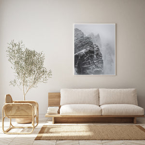 Vertical mountain landscape with layered snowy peaks and mist