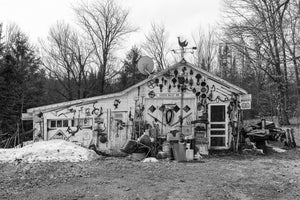 Weathered Ontario antique shop covered with old tools and signs