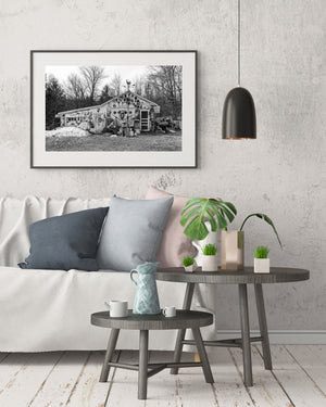Black and white rural shop surrounded by bare winter trees