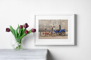Weathered urban vehicles parked along gray brick wall