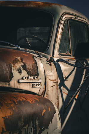 Weathered GMC 9500 emblem surrounded by rust