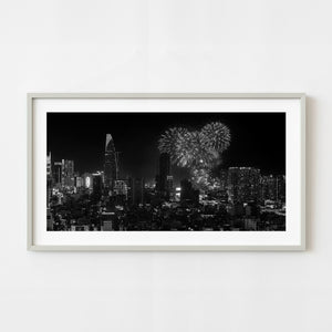 Black and white Saigon skyline with fireworks above the city at night