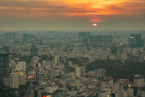 Dense Ho Chi Minh City cityscape with a low setting sun