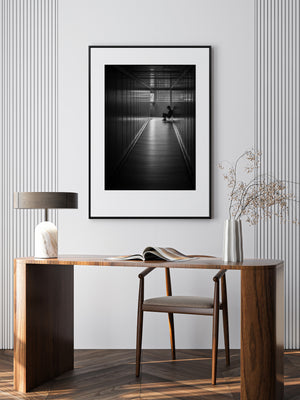 Solitary seated figure framed by light inside Vietnam airport