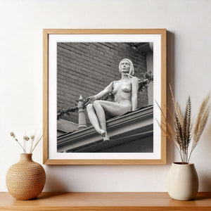 Quirky rooftop mannequin posed above an urban building