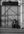 Woman seated outside a closed Naples storefront in hard sunlight