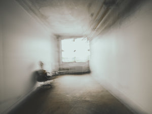 Blurred empty room with chair radiator and window