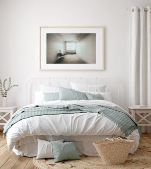 Motion blurred chair beside wall in sparse interior