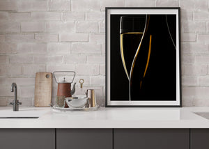 Dark bottle curve beside an illuminated wine flute