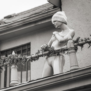 Black and white photograph of mannequin above Toronto street