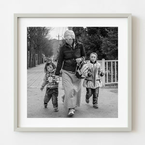 Tibetan mother walking with two children in Qinghai China