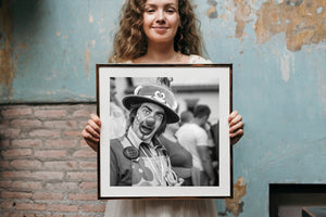 Clown with round nose and cartoon hat photographed in monochrome