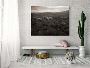 Small Italian village among orchards and cultivated hills
