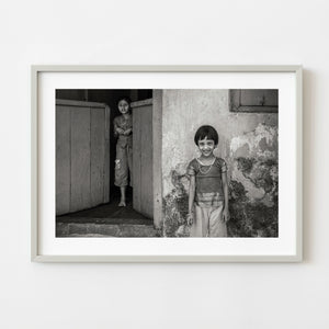 Two young sisters photographed in black and white in India