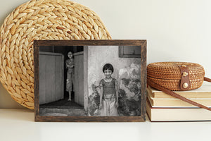 Black and white portrait of two girls outside a weathered building