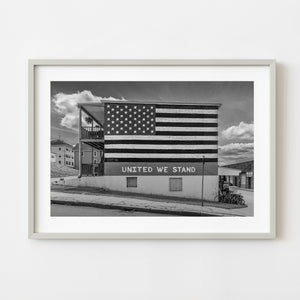United We Stand American flag mural painted on a brick building