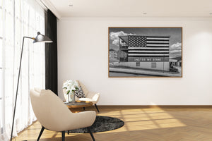 Large American flag mural covering the side of an urban building