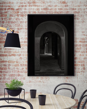 Black and white Vietnamese cultural portrait beneath stone archway