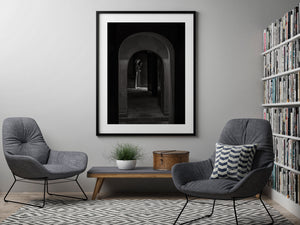 Monochrome portrait with conical hat and dark wooden doorway