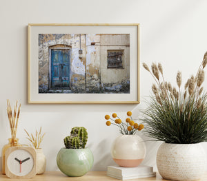 Textured old building facade with faded plaster and wooden door