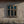 Old six-pane window set in cracked plaster wall