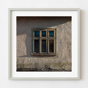Weathered farmhouse window in rural Romania