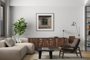 Aged wooden window surrounded by weathered Romanian plaster