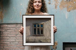 Warm sunlight and shadows across an old farmhouse window