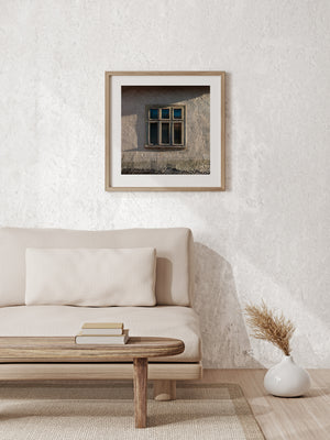Cracked plaster wall and timeworn window in rural Romania