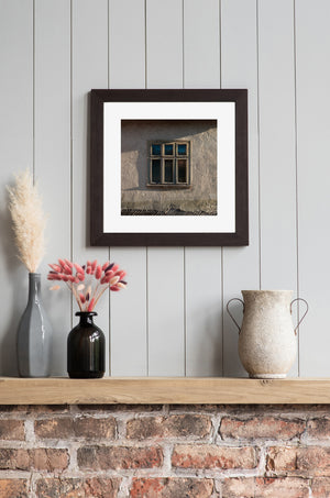 Architectural detail of an aged farmhouse window and textured wall