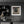 Rustic wooden window with peeling frames and dark glass