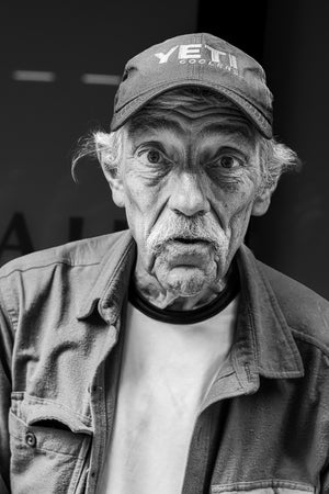 Close portrait of an elderly man wearing a baseball cap