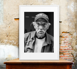 Manhattan street portrait showing weathered facial features and gray hair