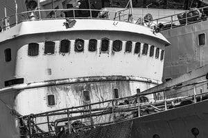 Aging commercial vessel with curved bridge windows and rust