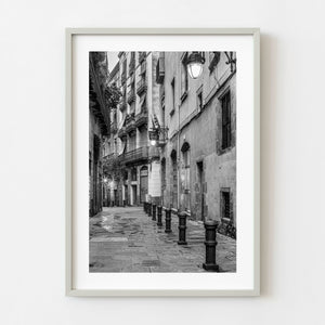 Black and white photograph of a wet street in Barcelona