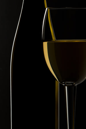 Golden white wine reflecting through clear glass