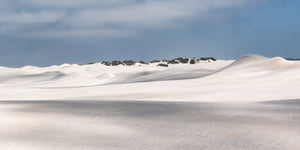 Wind-shaped pale sand dunes across Western Australian landscape
