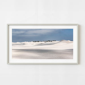 White sand dunes beneath blue-gray sky in Western Australia