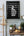 Vertical black and white portrait framed by ornate staircase details
