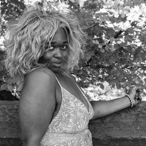 Woman with direct gaze and loose curly wig in New York portrait